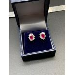A Pair of 18ct white gold Ruby & Diamond cluster earrings. [2.89ct's in total]