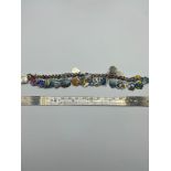 A Silver and enamel souvenir shield charm bracelet. [17cm length]