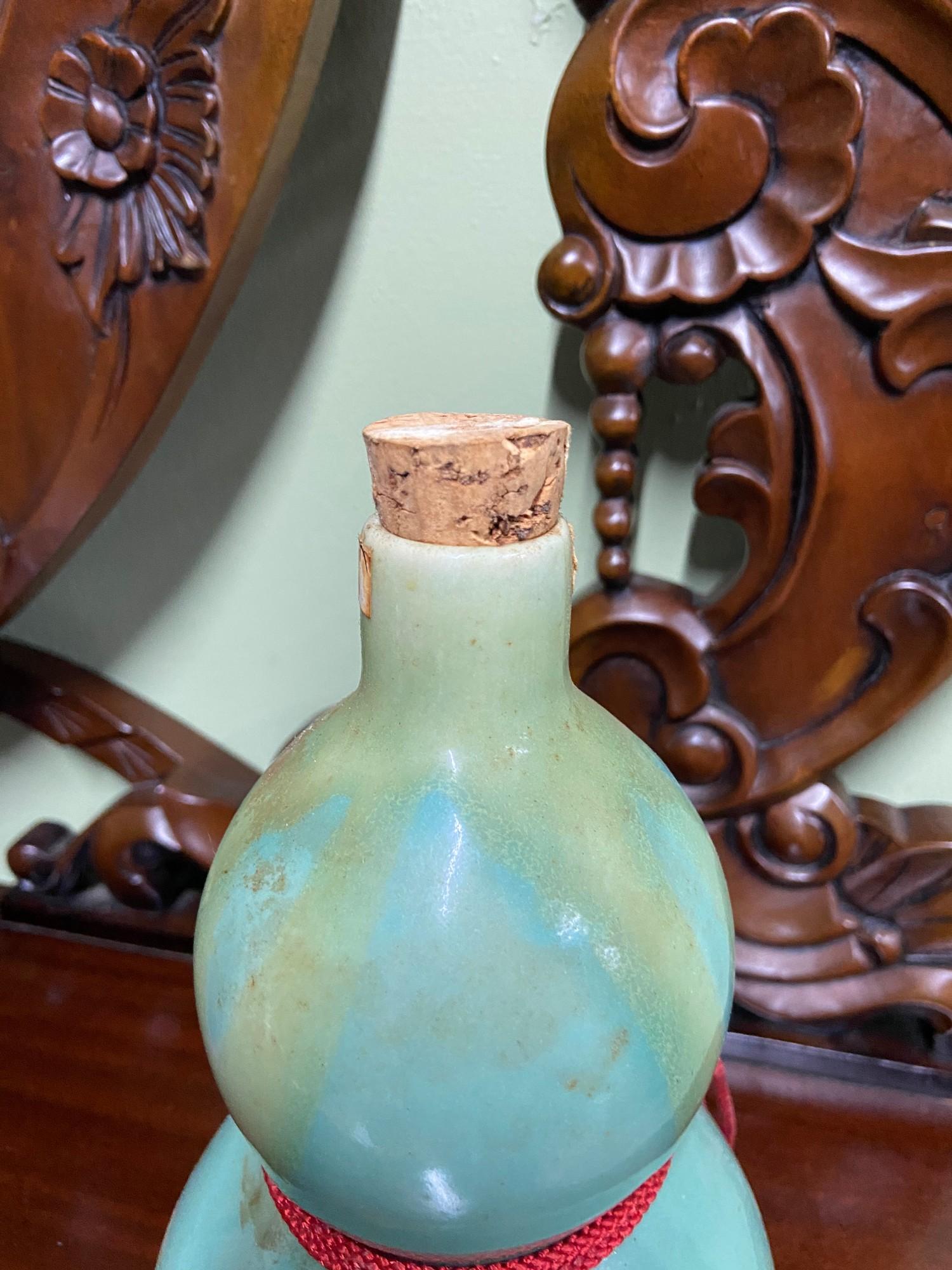 A Bottling of DOHKAN Saki within a green glazed decanter and cup. seal broken. - Image 3 of 4
