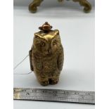 An unusual brass owl shaped sovereign case.