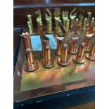 A Vintage Zimbabwe copper & brass bullet design chess pieces and board