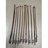 A Collection of various violin bows.