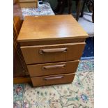 A Retro teak three drawer bedside cabinet.