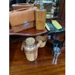 A Basket containing a selection of vintage and antique traveling items. The lot includes leather
