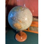 An Art Deco desk top globe. Designed with a wooden base detailed with a small compass. Finished with