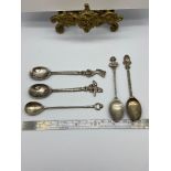 Four Egyptian silver souvenir tea spoons together with an 800 silver tea spoon.