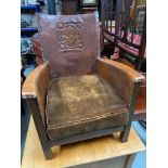 An early 1900's Arts and crafts leather arm chair. Designed with An English rose design to the