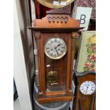 Antique wall clock designed with a mahogany case. Comes with pendulum and key. [86cm length]