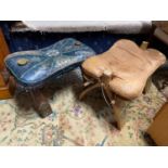 A Lot of two vintage camel stools designed with brass plaques and leather cushion seat.