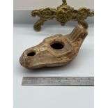 An Ancient Roman oil lamp. [9.5cm length]