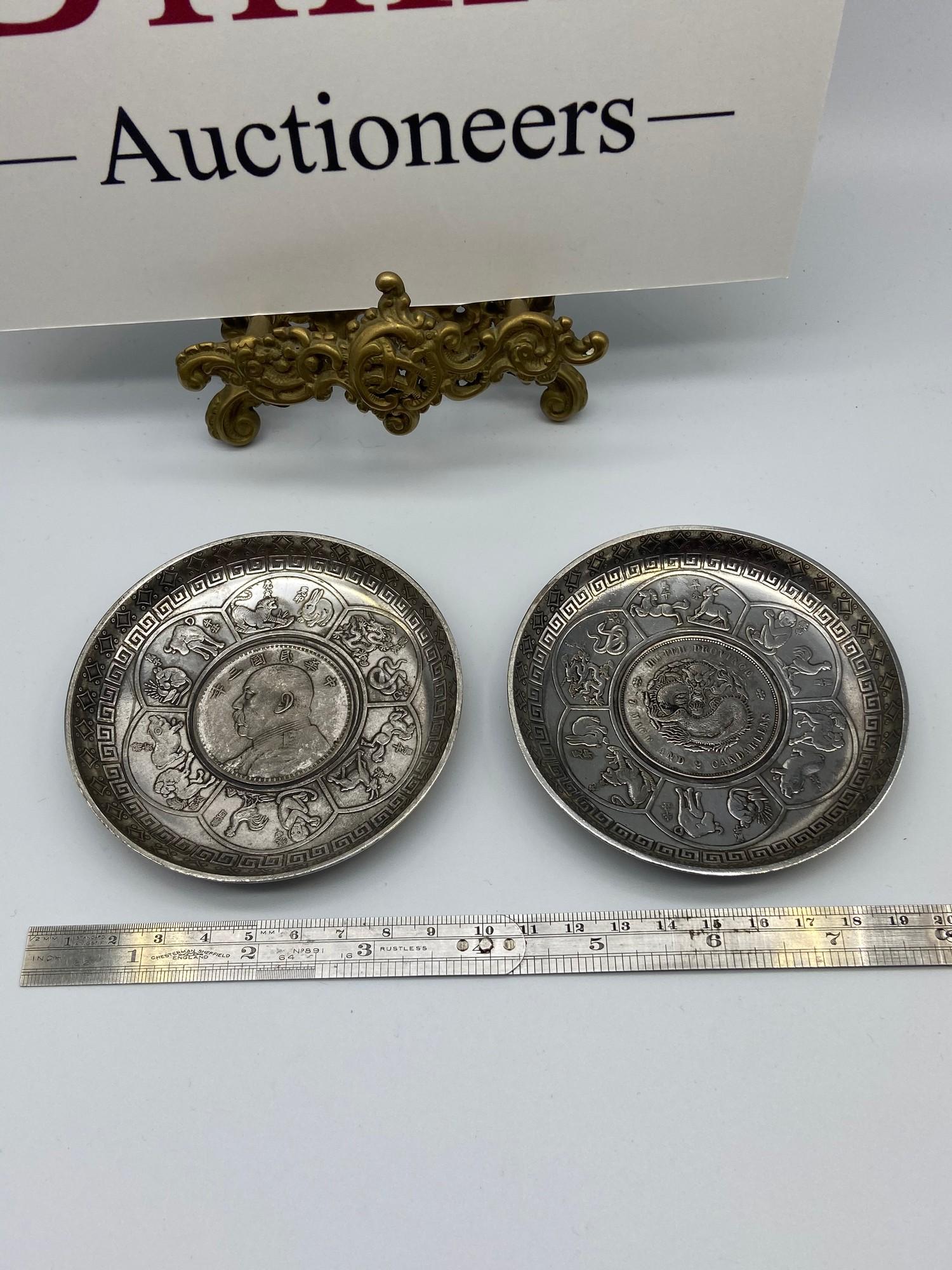 A Pair of silver plated Chinese Zodiac pin dishes with coin inserts.
