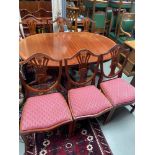 A Reproduction William Tillman style dining table with extra leaf. Together with two carvers and