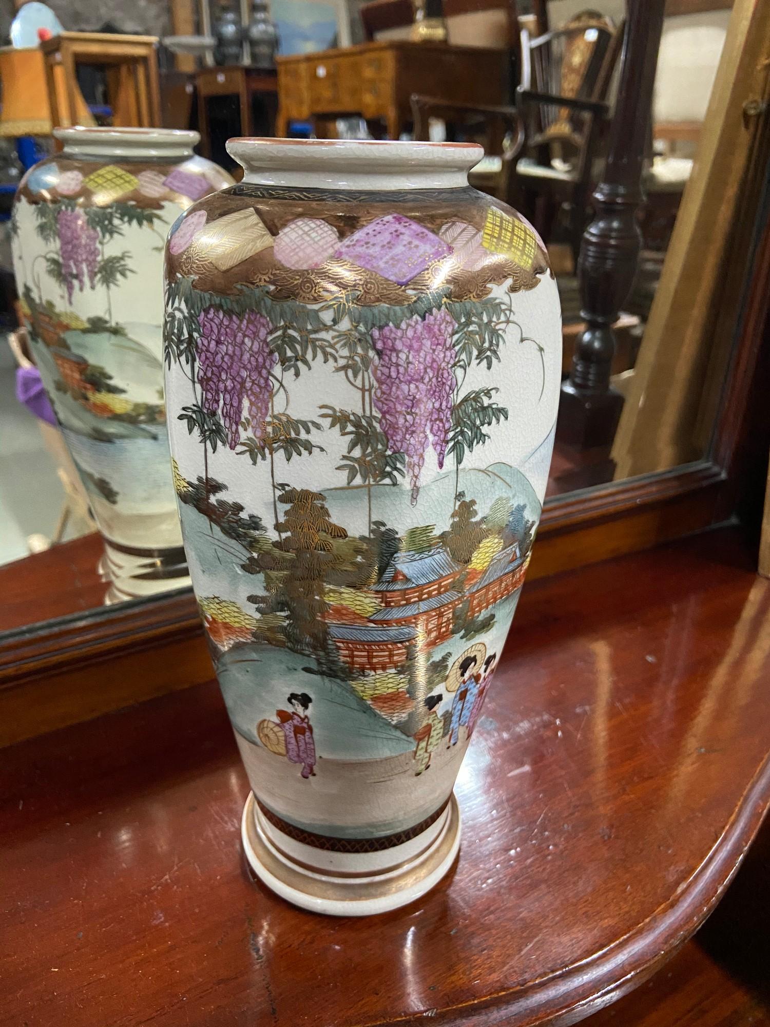 An early 20th century Japanese Satsuma hand painted vase. Signed to the base. [25cm height]