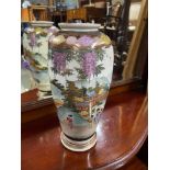 An early 20th century Japanese Satsuma hand painted vase. Signed to the base. [25cm height]