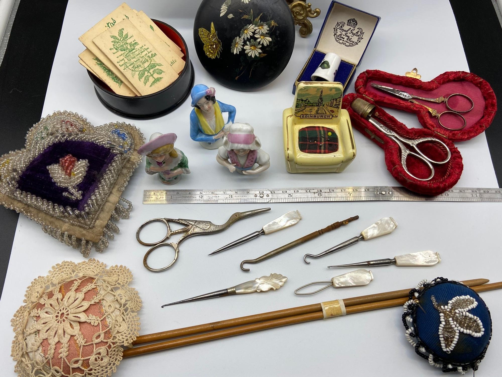 A Selection of collectable sewing items which includes three porcelain pin cushion ladies, Various