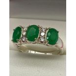 A Silver 925 ring set with CZ and Green hard stones.[Ring size P]