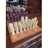 A Vintage wooden chess board together with animal character chess pieces.