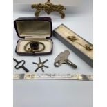 Two antique pocket watch keys, Meccano clock work key, Victorian large brooch [A/F] and a possible