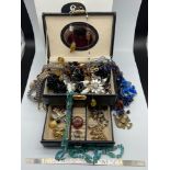 A Jewel box containing a quantity of mixed vintage and contemporary costume jewellery. Includes