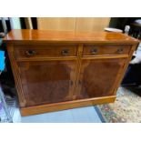 A Vintage yew wood console cabinet designed with two drawers and two doors. Comes with keys.