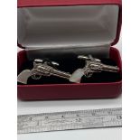 A Pair of Sterling silver pistol cufflinks with mother of pearl handles.