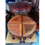 An oriental hardwood table with four pull out tables/ stools. All designed with ball and claw feet.