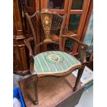 An impressive Edwardian arm chair, detailing various urn and ribbon inlays .