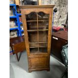 Antique style tall narrow display cabinet. Designed with a glass panel door and fitted shelf