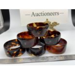 A set of 6 tortoise shell napkin rings Designed with a silver R initial inlay to each.