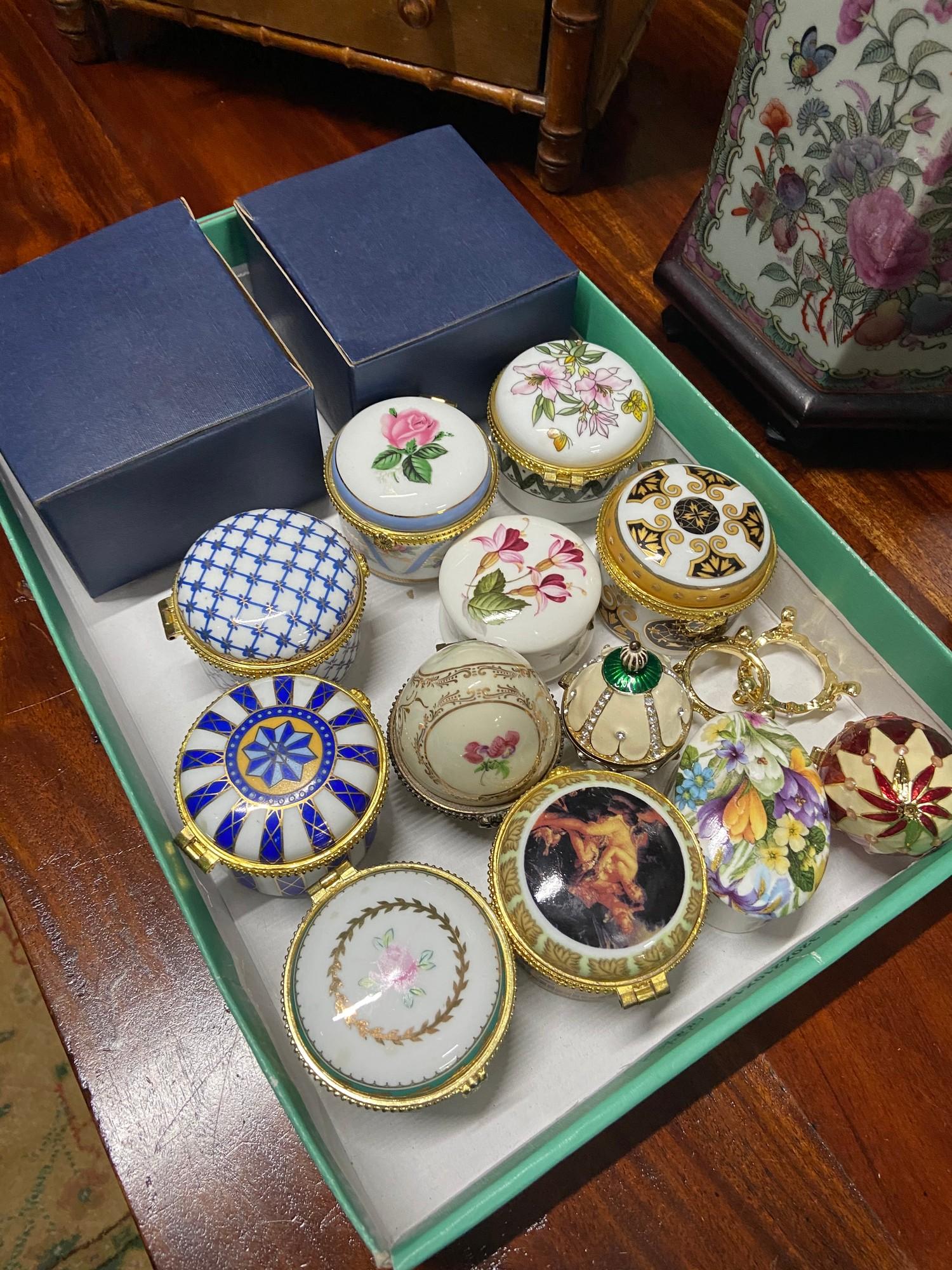 A Tray of various ornate trinket boxes. Some in the shape of eggs.