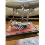 A Silver Chinese Junk boat model within a glass display. [Ship model stands 20cm in height]