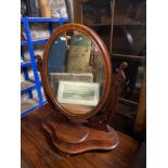A Victorian mahogany framed shaving mirror with small compartment.