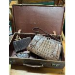 A Vintage travel case containing a crocodile leather hand bag and two purses.