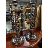 A Pair of antique oak barley twist candle sticks with brass ornate tops. [36.5cm height]
