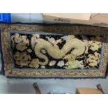 A 20th century hand made Chinese Dragon design rug/ wall hanger. Measures 158x83cm includes black