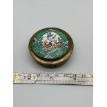 An Indian pill box designed in a plated/ gilt metal, with enamel painted lid and engraved sides. [