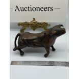 A Chinese Bronzed effect bull sculpture. [13cm length]
