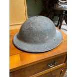 WW2 Military helmet dated 1940. Has original straps present.