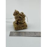 An unusual gilt metal document fob seal designed with a cat sitting to the top with emerald eyes.