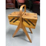 A Vintage 1960's 70's cantilever sewing box. Includes various sewing utensils.