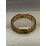 A 9ct gold band ring set with 6 fitted clear stones. [Ring size L] [2 Grams]