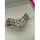 A Ladies 9ct gold and diamond ring in a wish bone design. [0.88cts][Ring size I] [2 Grams]
