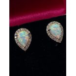 A Pair of 925 silver cz and pear shaped opal stud earrings on silver posts. Comes with