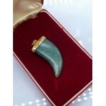 A Yellow metal and Jade horn pendant.