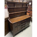 A Vintage elm wood Ercol dresser. Designed with four drawers and two doors.