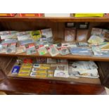 Two shelves of collectable train accessories which includes Platforms, Station accessories and