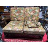An Ercol two seat cottage sofa and an Ercol single arm chair.