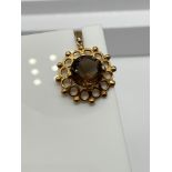 A Ladies 9ct gold pendant designed with a single large Smokey quartz stone. [3 Grams]
