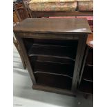 An Ercol elm wood book case designed with adjustable shelves.