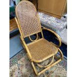 A Retro bamboo and ratten back rocking chair.